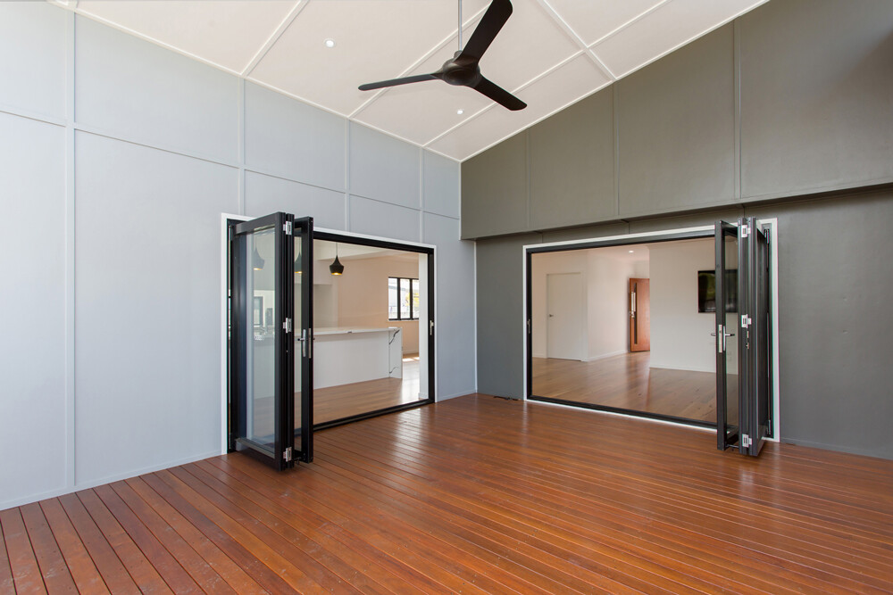 Rear timber deck extension with fan and modern 3 panel bi-fold doors